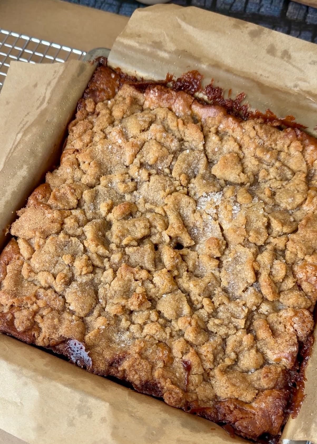 An overhead view of the baked cake with the parchment folded away from its edges