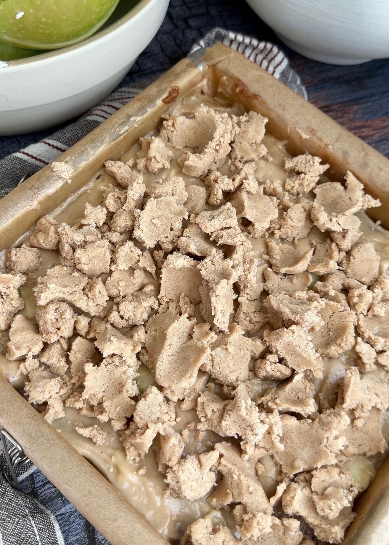 Large uneven crumble clusters covering the cake batter