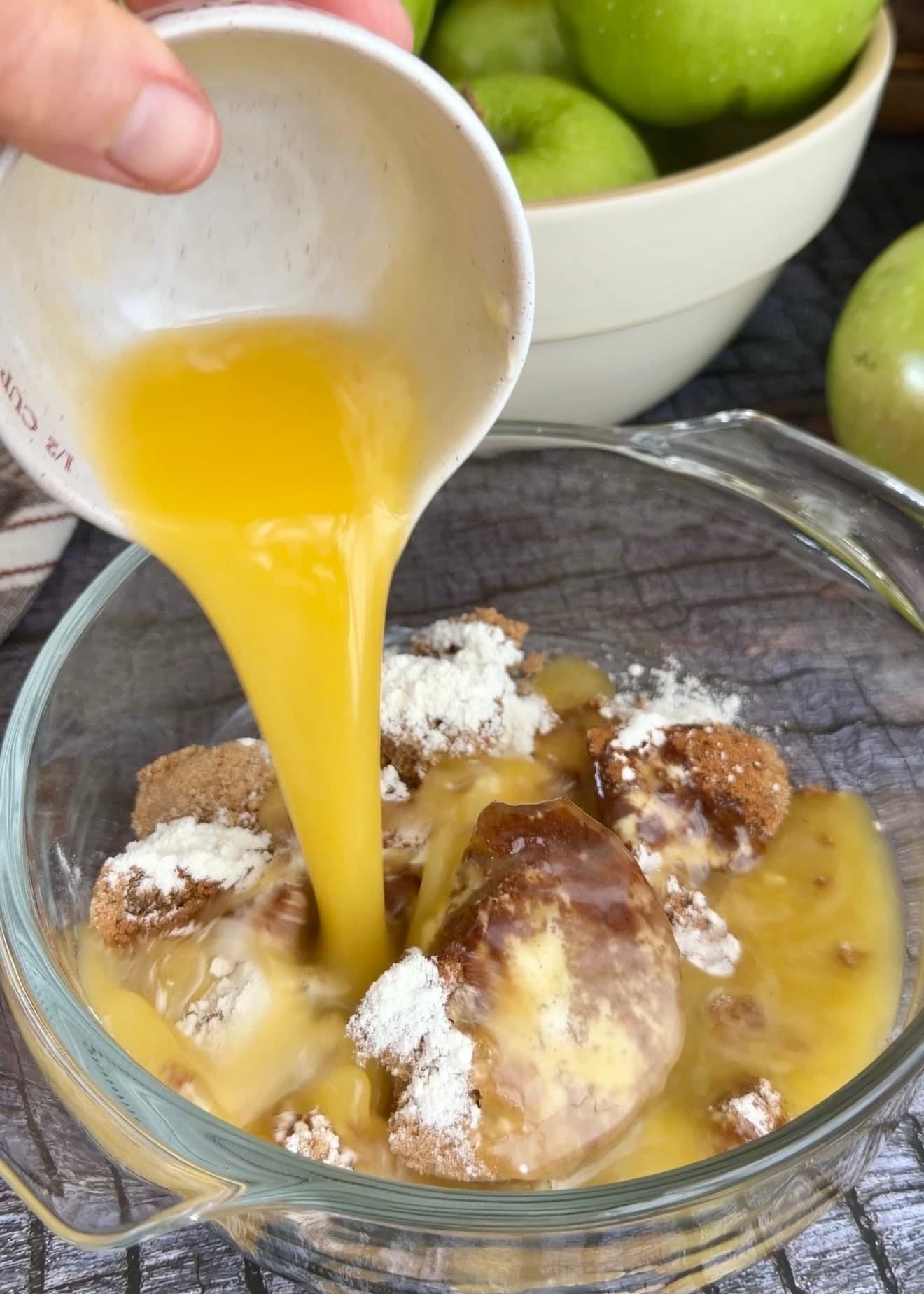 Melted butter pouring into a bowl of brown sugar and dry swirl ingredients