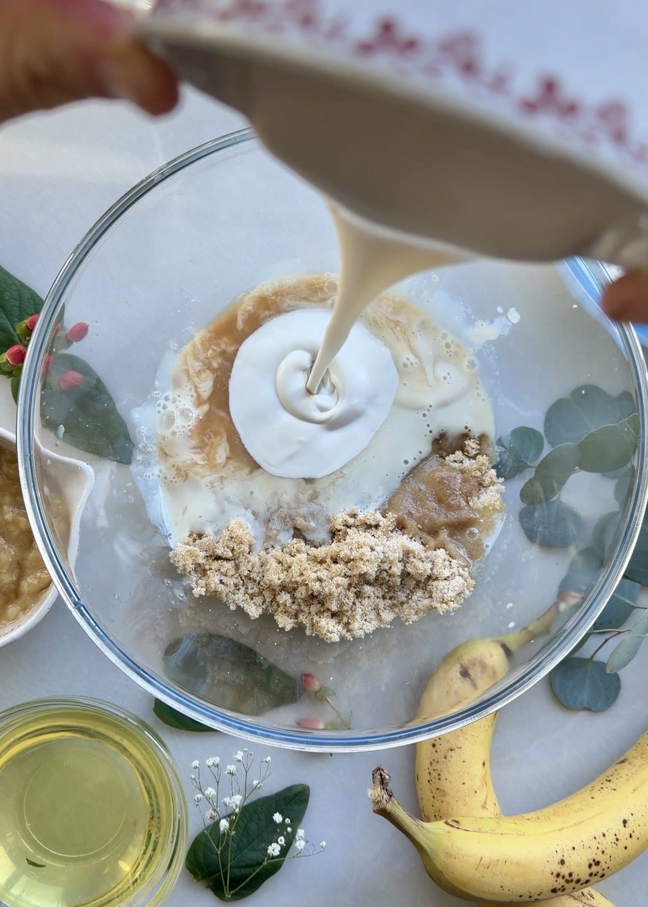 Yogurt being poured into a bowl with sugars