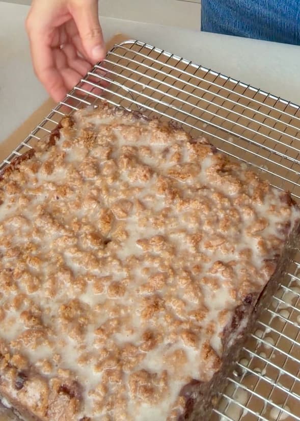 The glazed banana cake upright on a wire rack