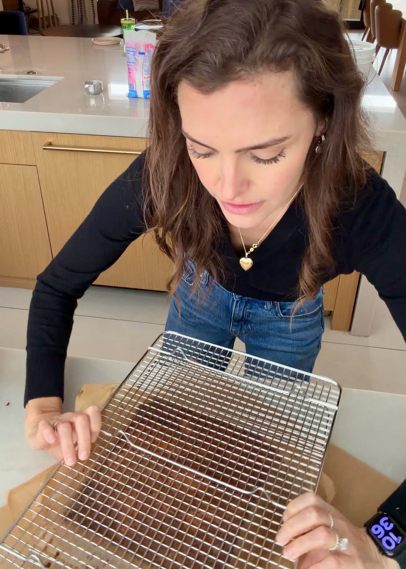 A second wire rack held across the top of the baked cake
