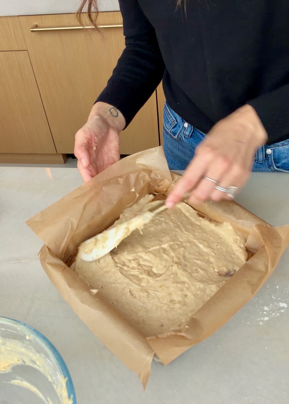A spatula smoothing the upper layer of banana batter