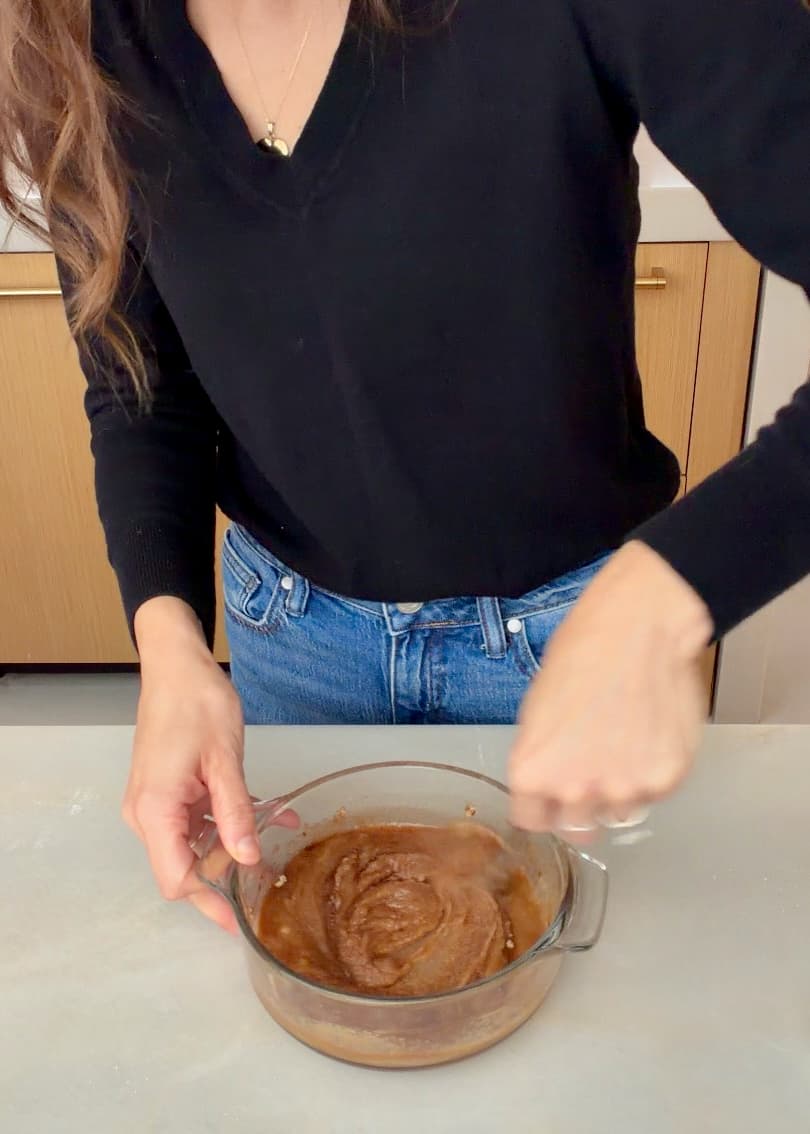 A spoon stirring the thick brown cinnamon filling