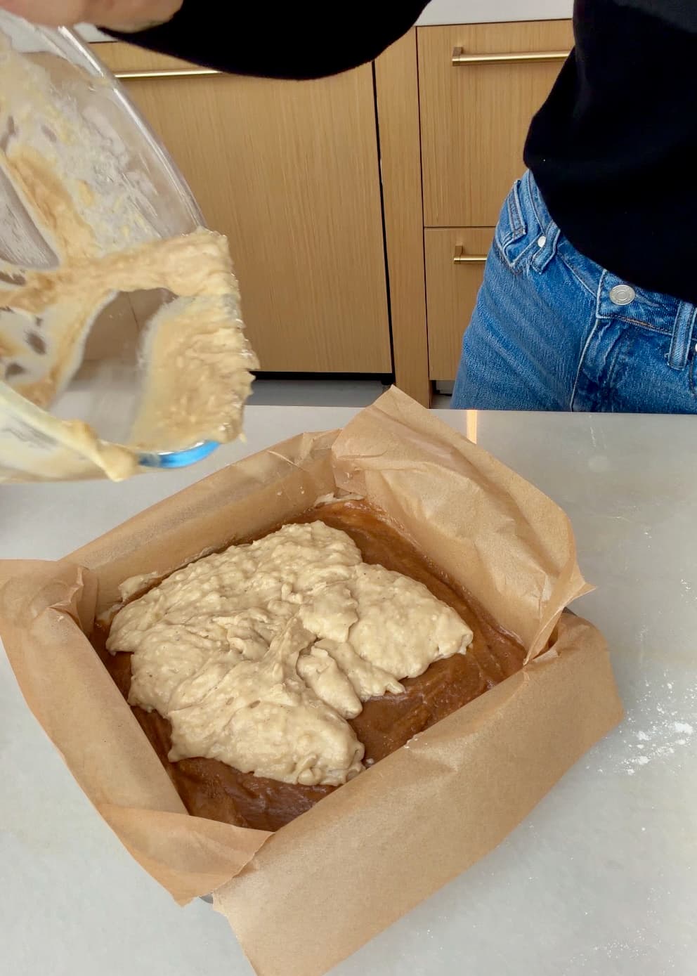 Several dollops of banana batter resting on the cinnamon filling