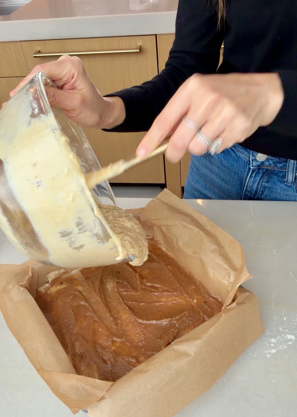 Remaining banana batter being added over the cinnamon filling