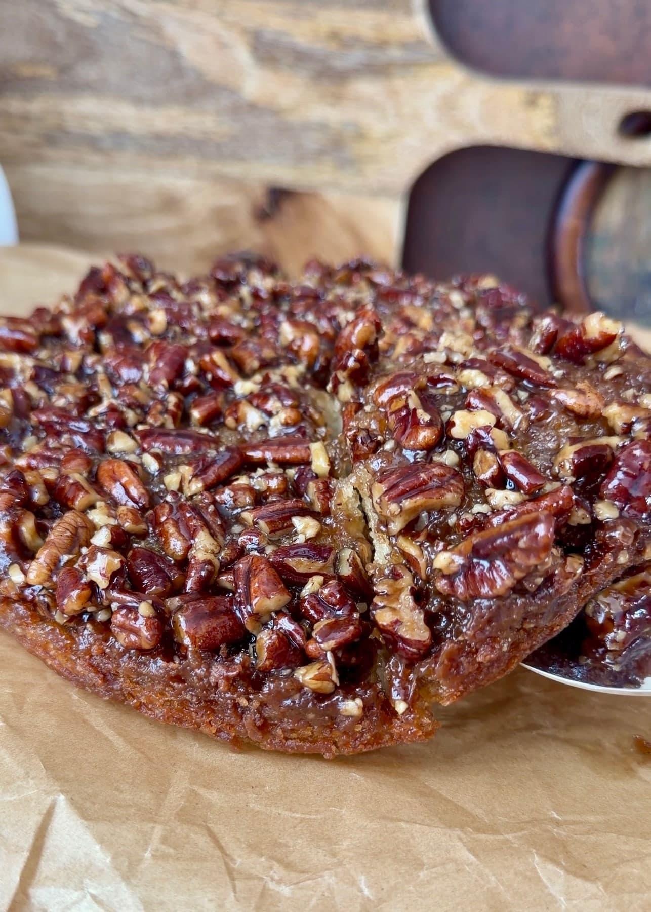 A wedge of banana sticky bun cake lifted from the whole cake