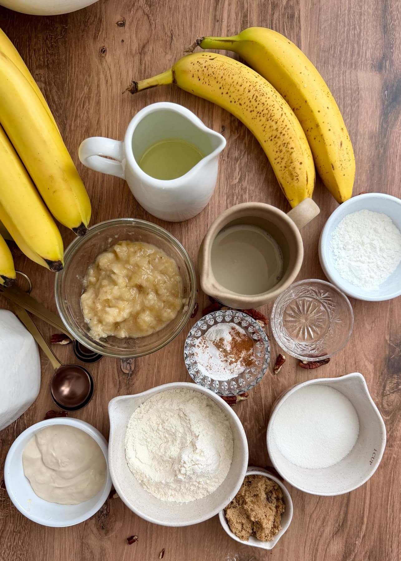 Measured banana cake ingredients arranged on a wooden table