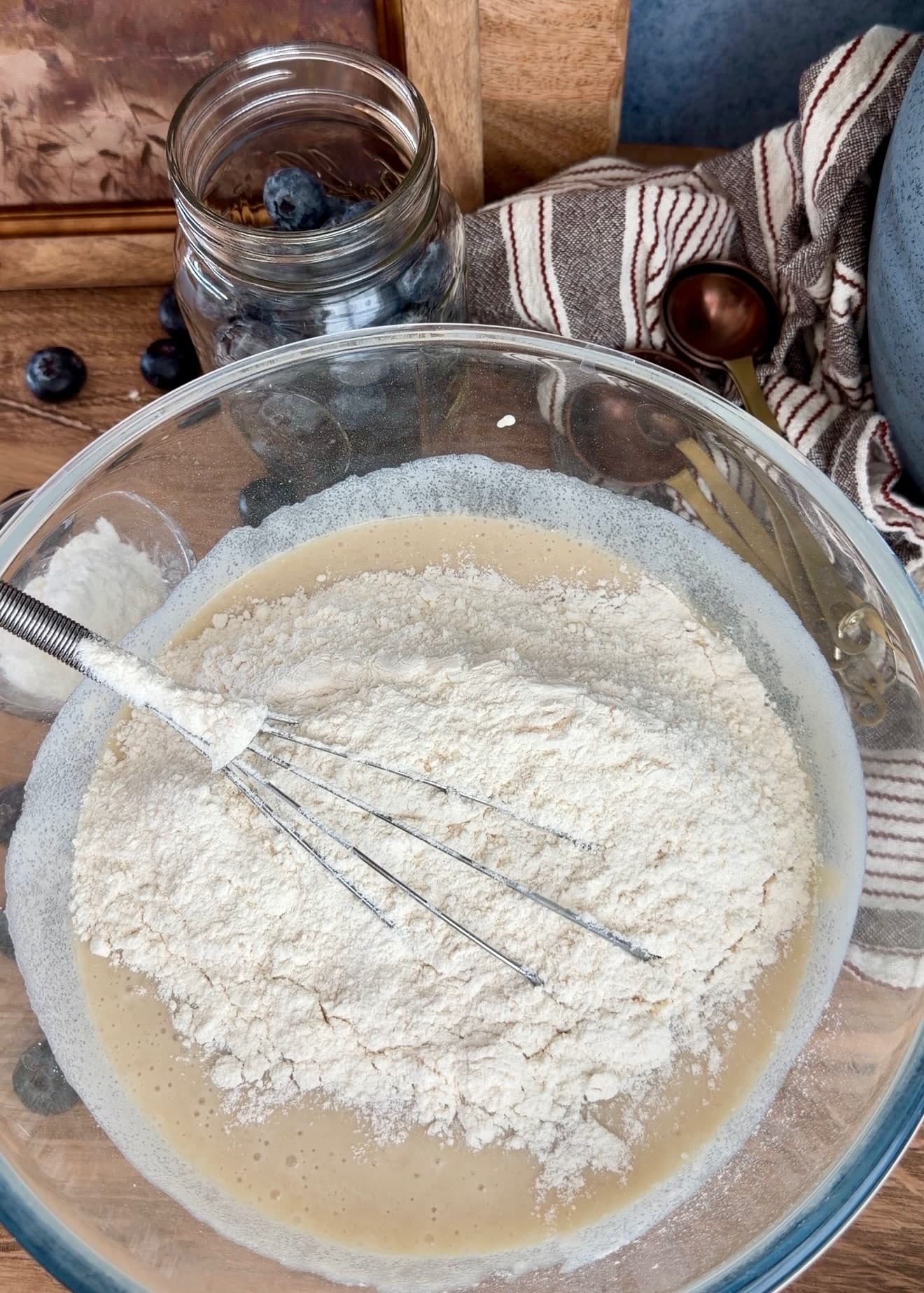 Dry ingredients covering the wet mixture around a whisk