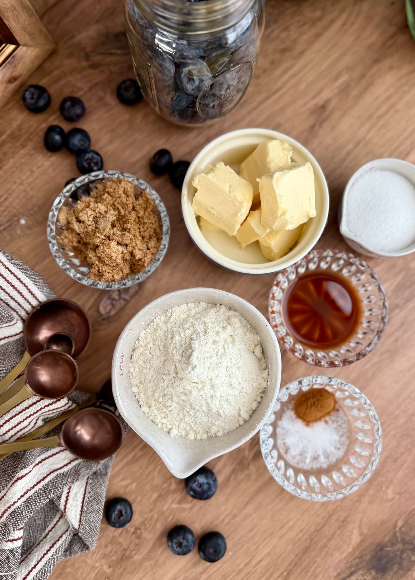 Flour, butter, brown sugar, granulated sugar, and flavorings arranged for the crumble