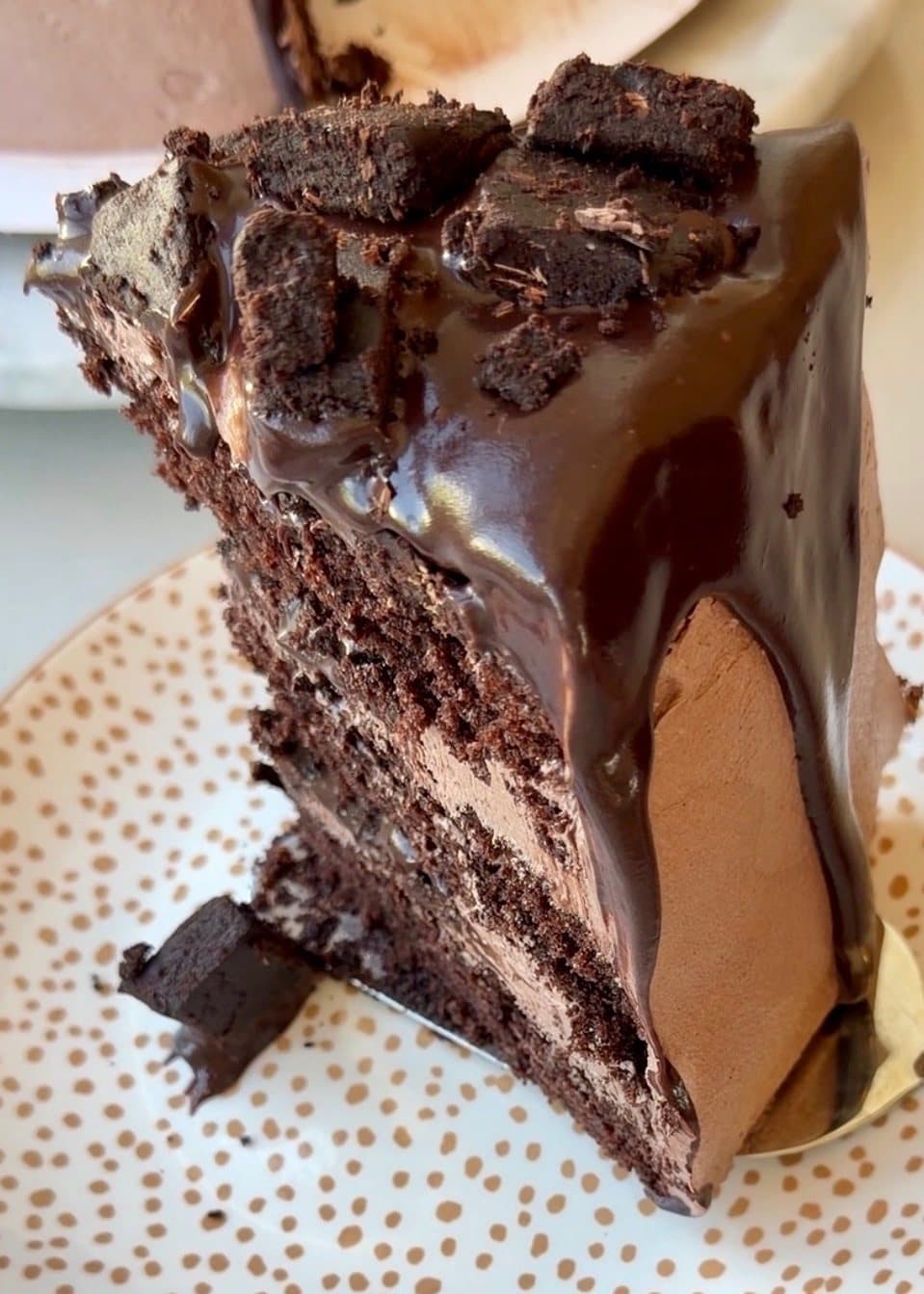 Brownie Lava Cake slice topped with chocolate filling and brownie pieces.