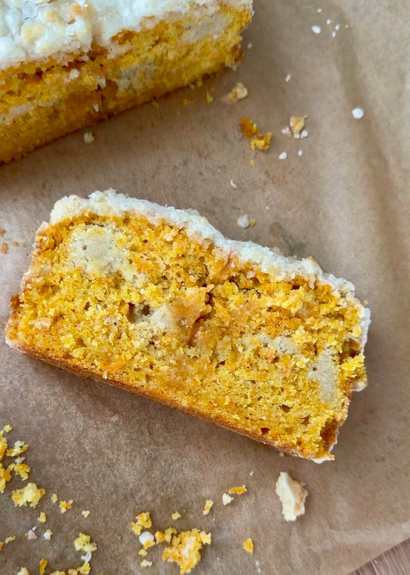 A glazed slice of carrot cake donut loaf with streusel inside