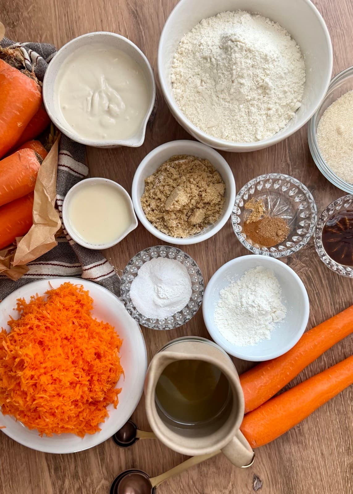 Finely grated carrots, flour, sugars, yogurt, milk, oil, and other loaf ingredients