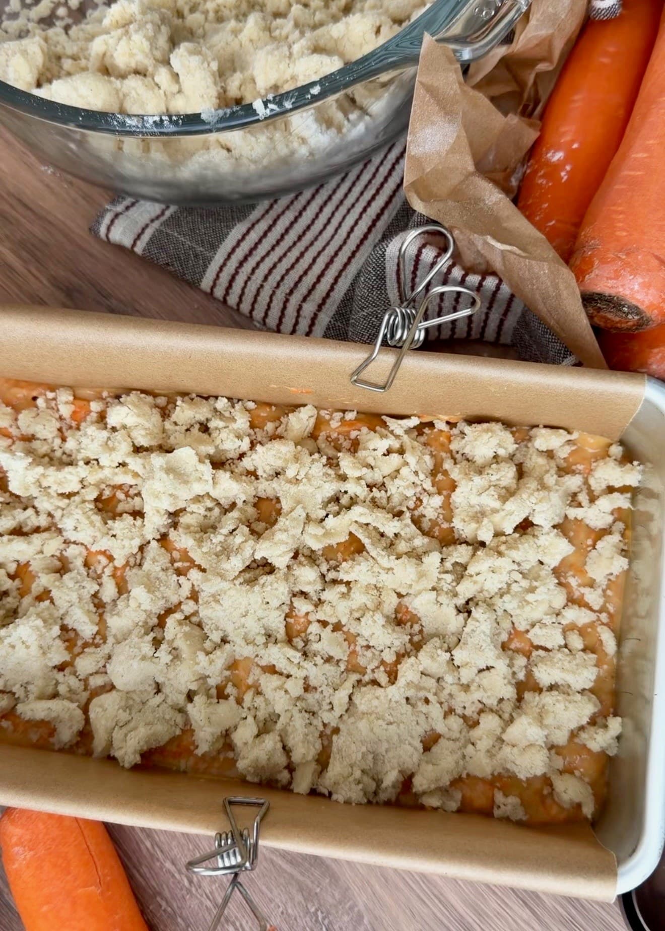 A layer of pale streusel covering carrot batter