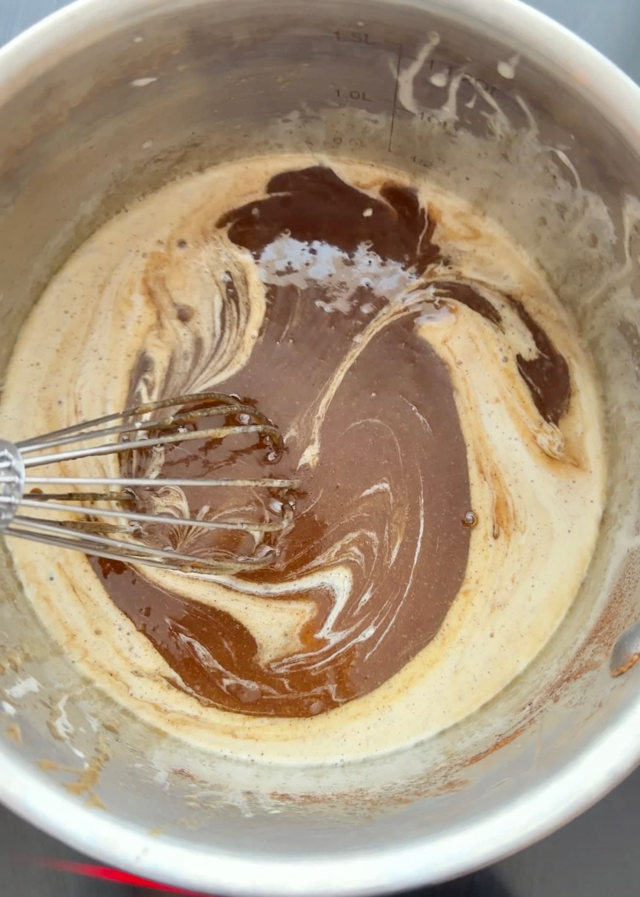 Cream being whisked into the cinnamon roll filling