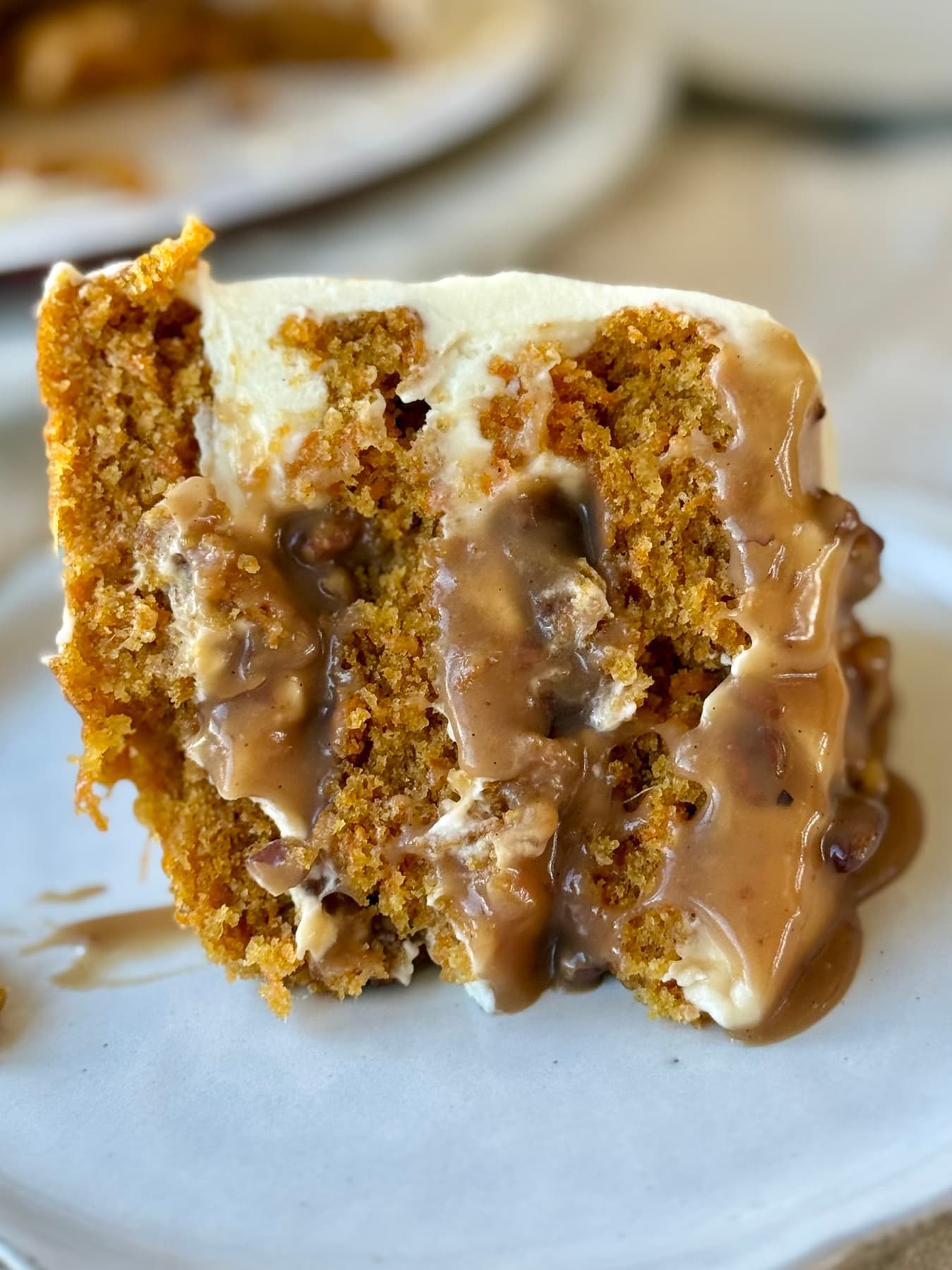 Plated slice of Carrot Praline Cheesecake Cake with pecan caramel filling