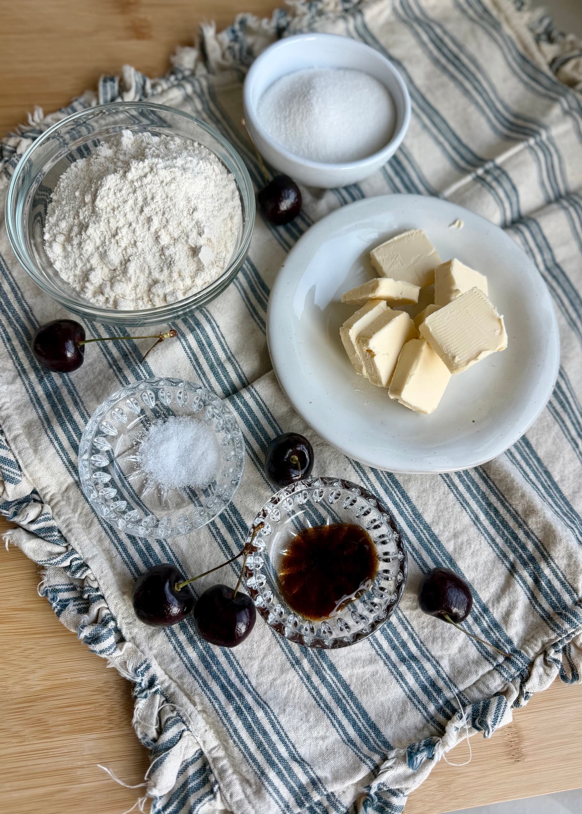 Measured streusel ingredients in bowls beside butter
