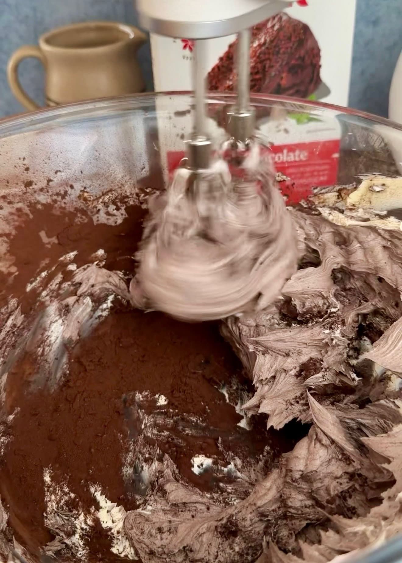 Hand-mixer beaters combining cocoa with the butter mixture