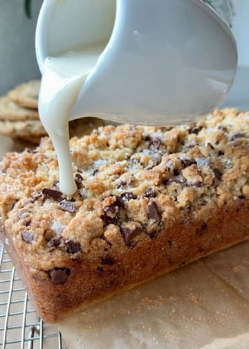 Vanilla glaze pouring onto chocolate chip streusel