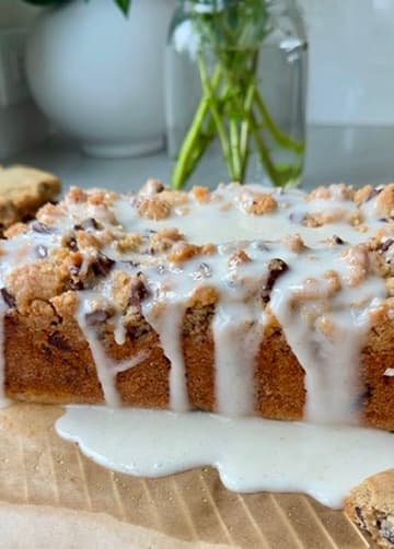 Glaze dripping down the side of a chocolate chip loaf