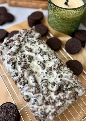Finished glazed Oreo loaf with cookies beside it