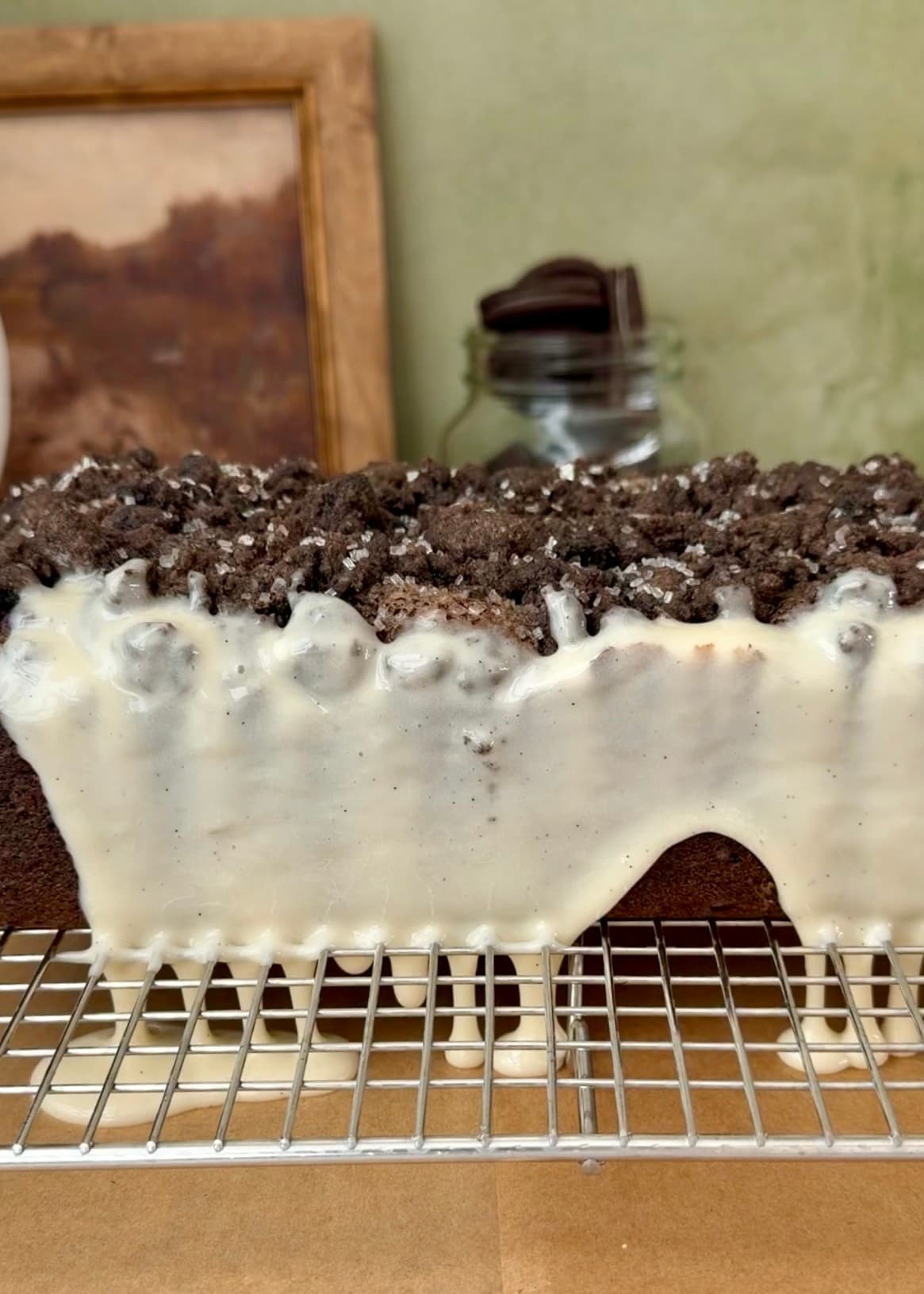 Vanilla glaze dripping down the side of the loaf