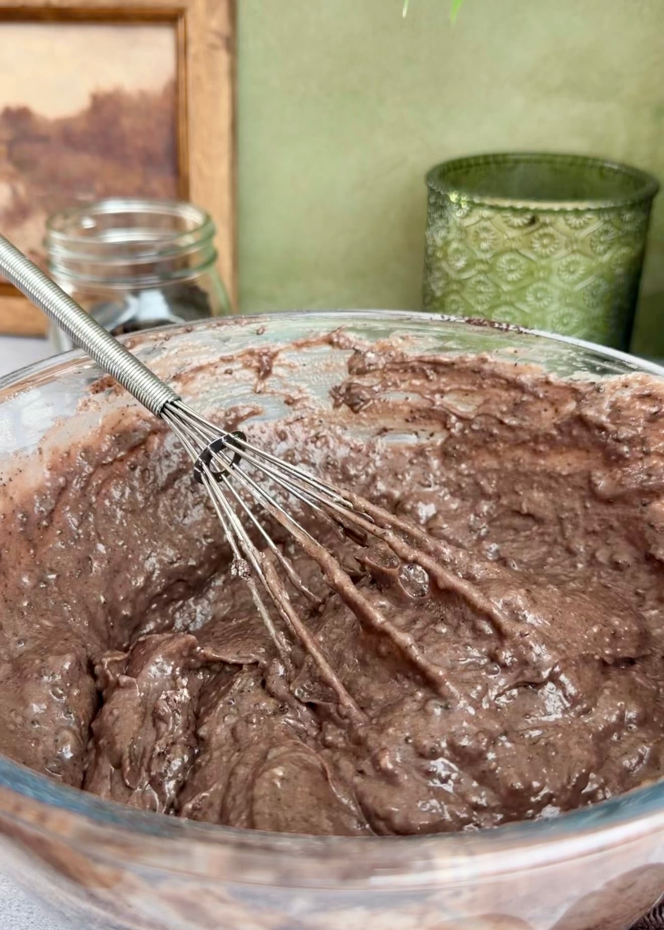 Thick chocolate batter with a whisk resting in the bowl