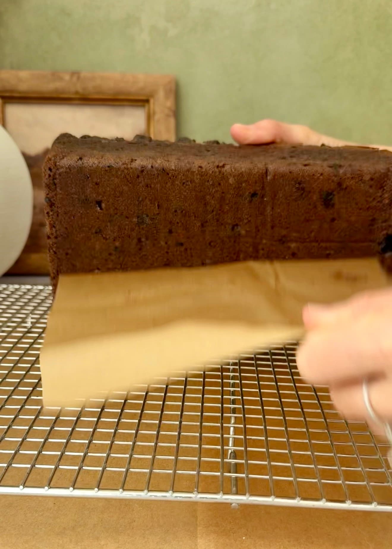 Parchment being peeled away from the bottom of the loaf
