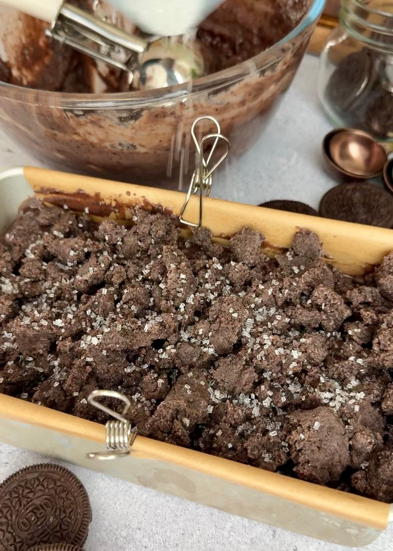 Coarse sugar being sprinkled over the streusel