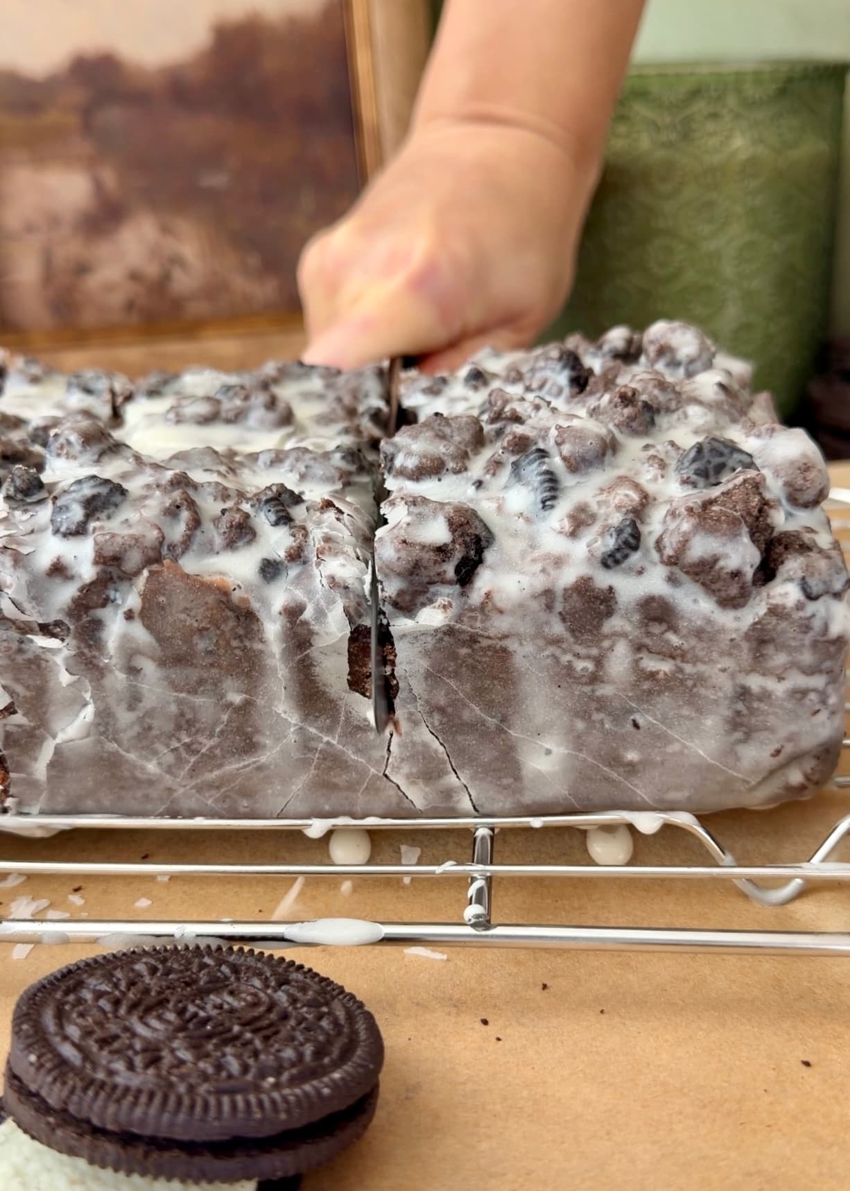Side view of a knife slicing the glazed loaf