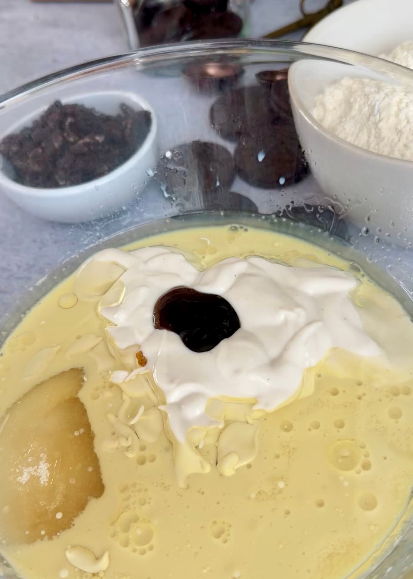 Milk, yogurt, oil, sugar, and vanilla in a glass bowl