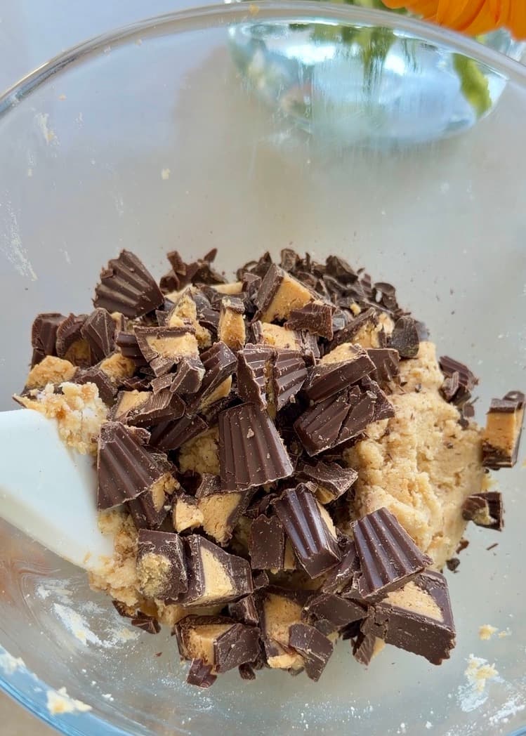Chopped peanut butter cups over a bowl of streusel