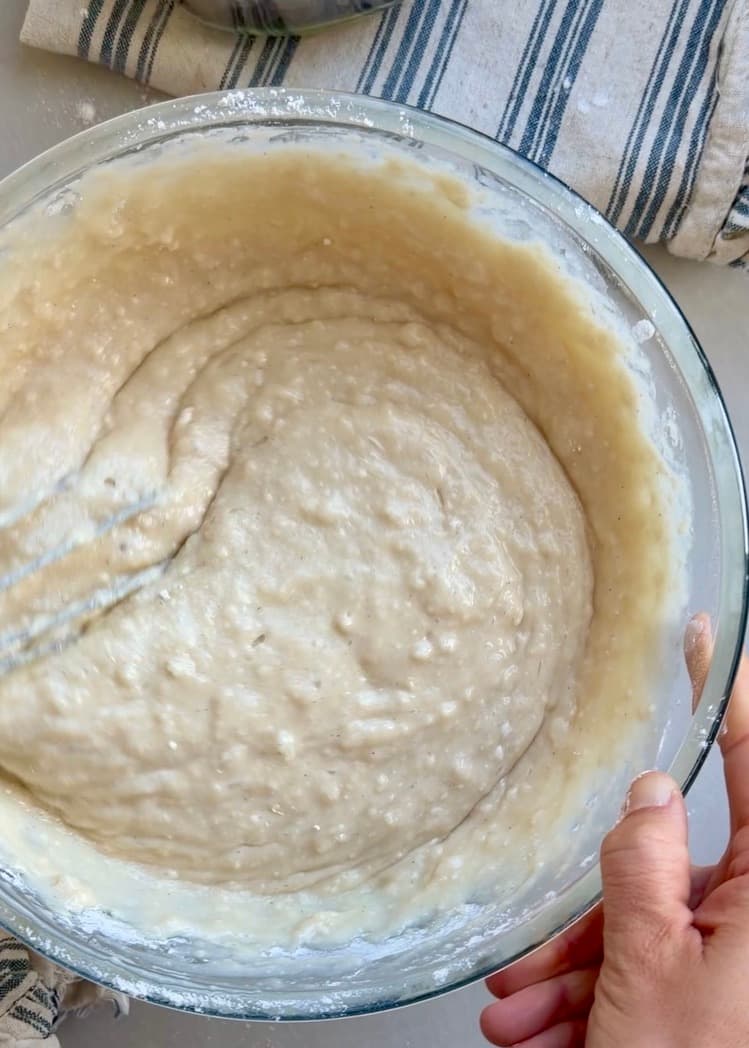 Smooth vanilla cake batter in a glass bowl
