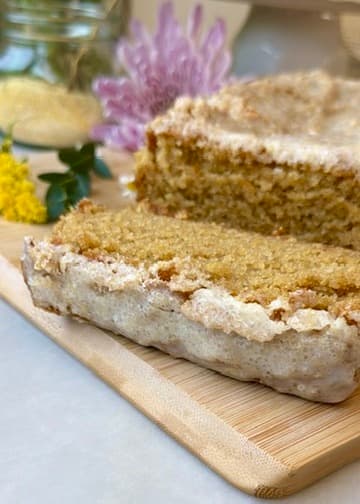 Sliced glazed cornbread loaf on a wooden board
