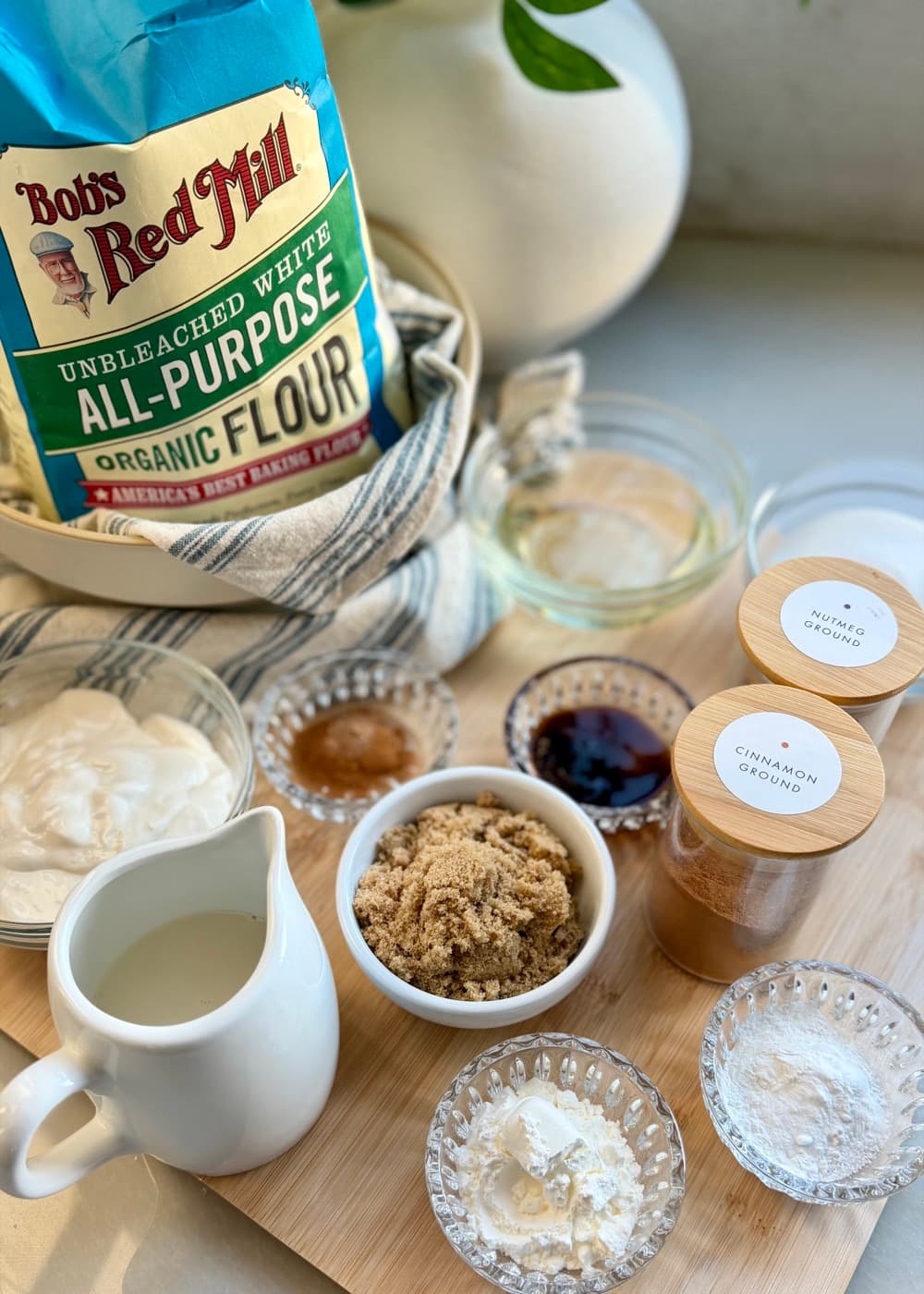 Ingredients for French toast donut loaf including cinnamon, nutmeg, brown sugar, yogurt, milk, and flour