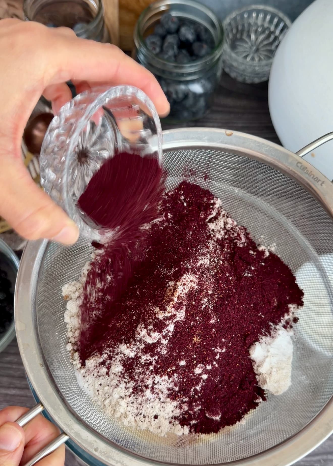 Deep purple freeze-dried blueberry powder on the pale dry ingredients