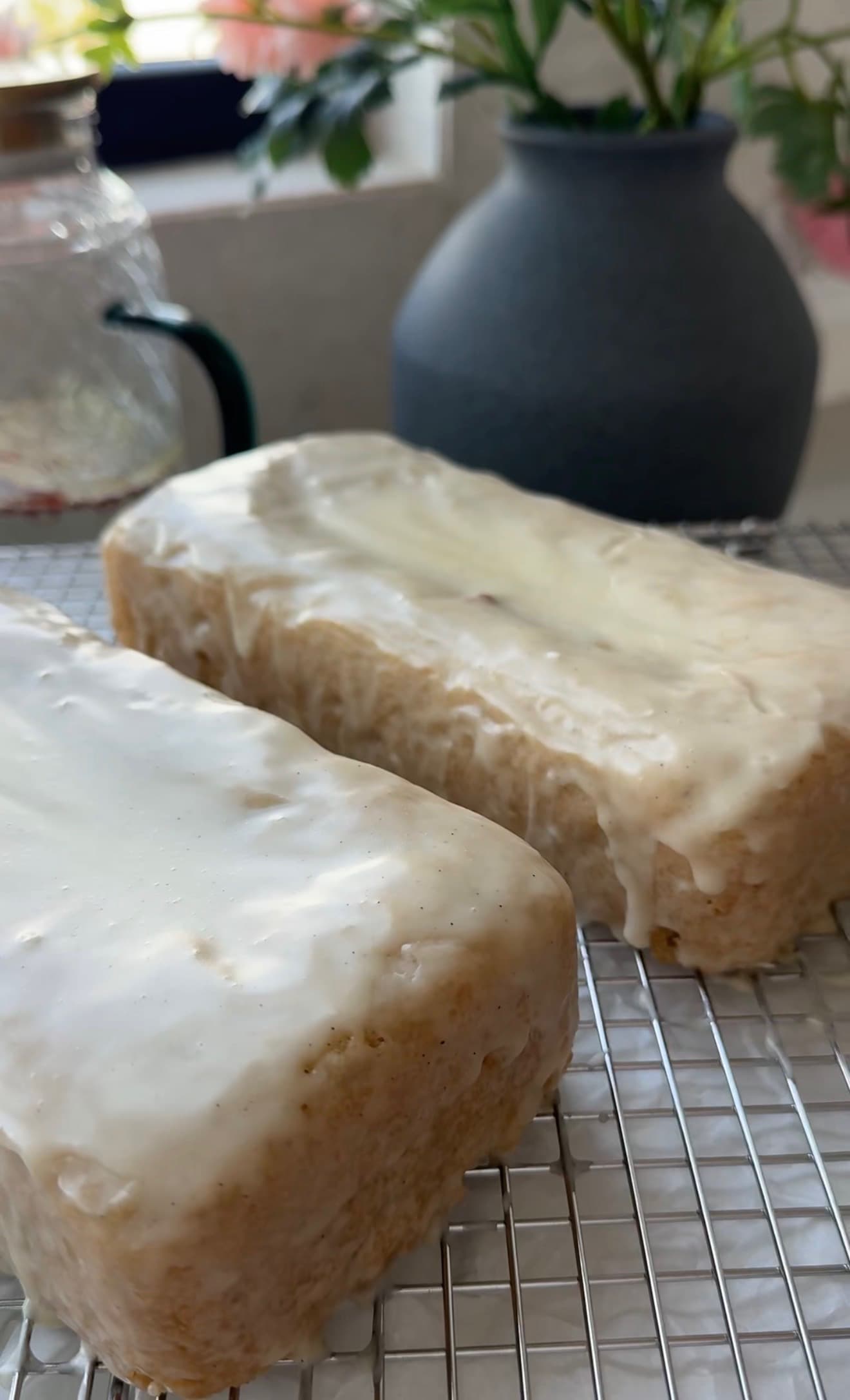 Two glazed gluten-free old-fashioned donut loaves cooling on a wire rack