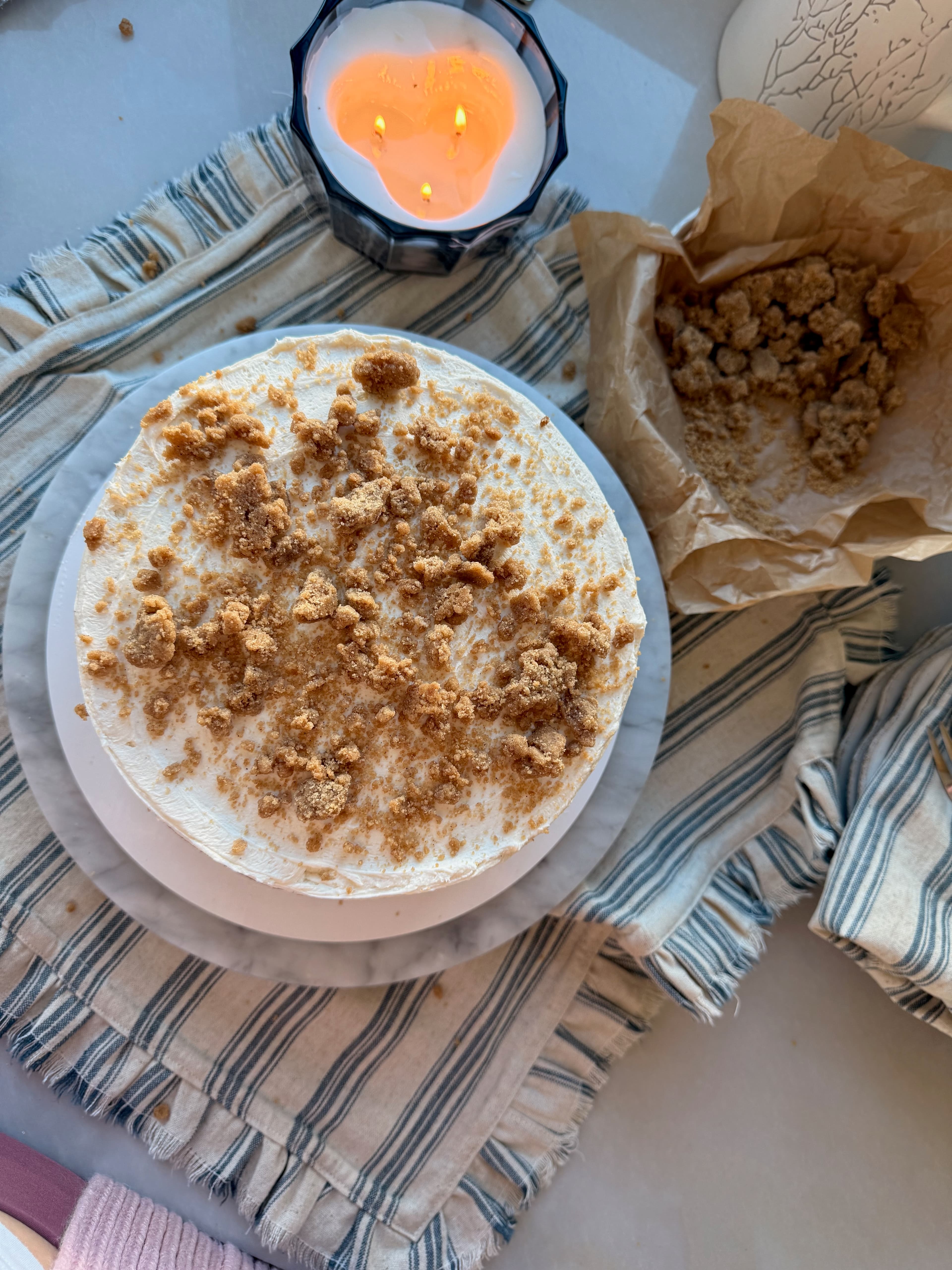 Overhead view of a frosted layered coffee cake covered with cinnamon streusel
