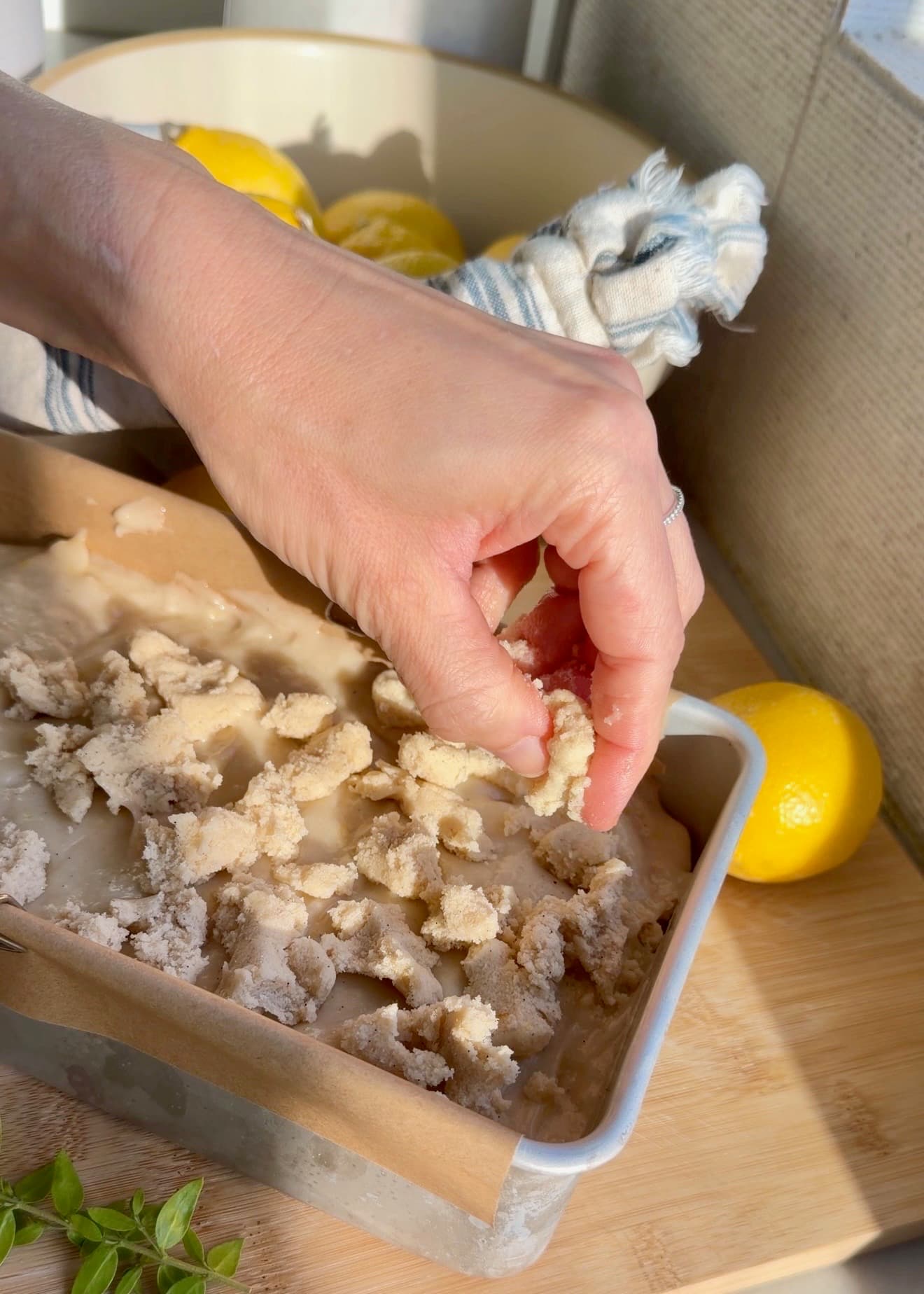 Large streusel clusters scattered over lemon loaf batter before baking