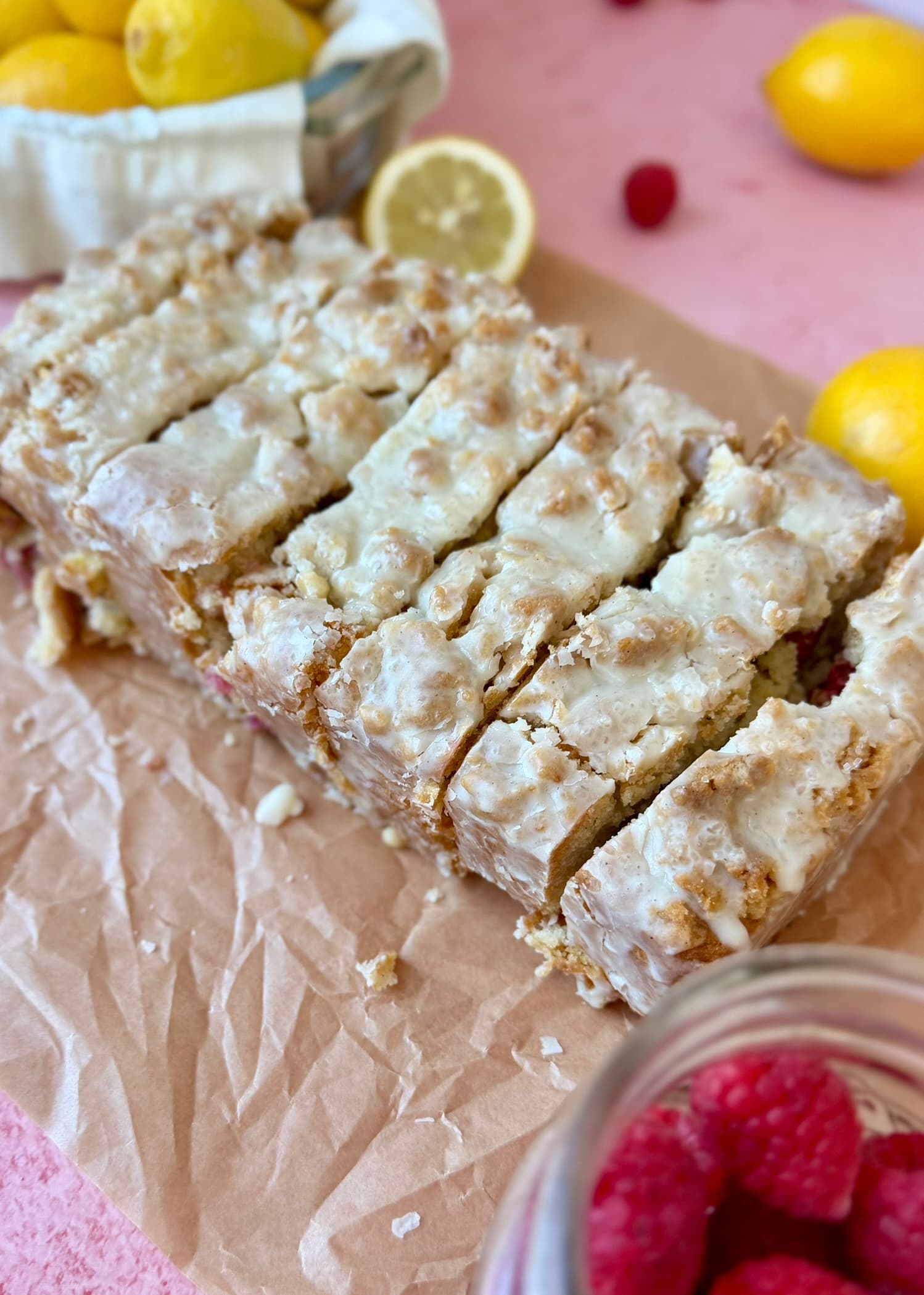 Finished glazed Lemon Raspberry Donut Loaf sliced to show raspberry pockets