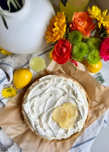 Finished Limoncello Cheesecake Mousse topped with softly swirled whipped cream and lemon slices