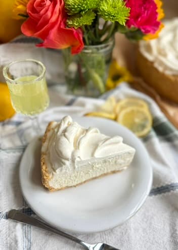 Plated slice of Limoncello Cheesecake Mousse with limoncello and colorful flowers