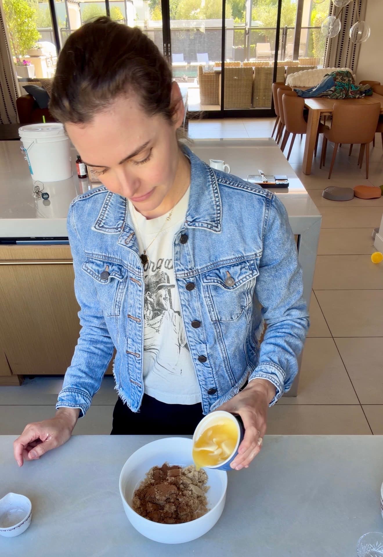 Melted butter pouring into a bowl of brown sugar and cinnamon filling ingredients