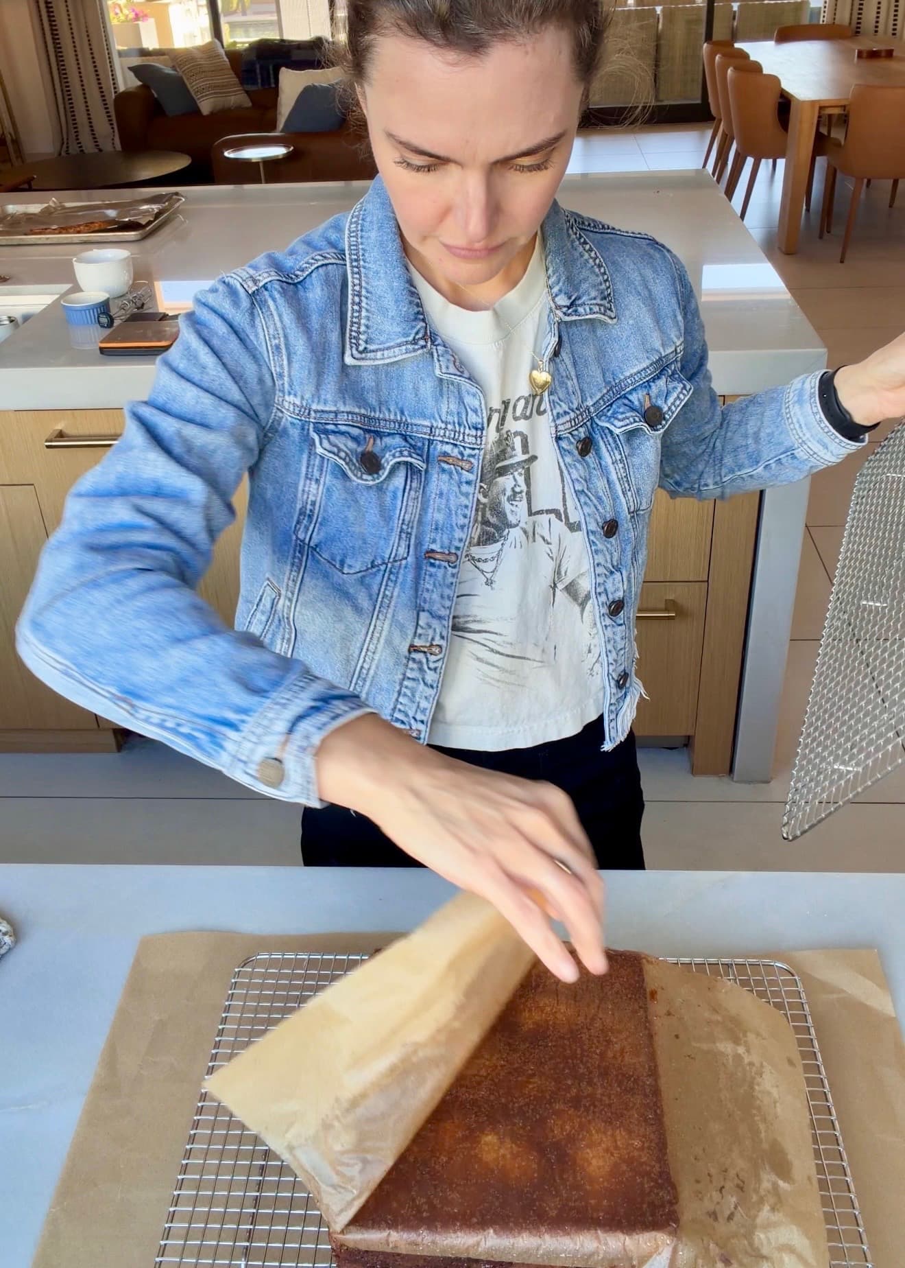 Parchment being peeled from the base of the inverted coffee cake