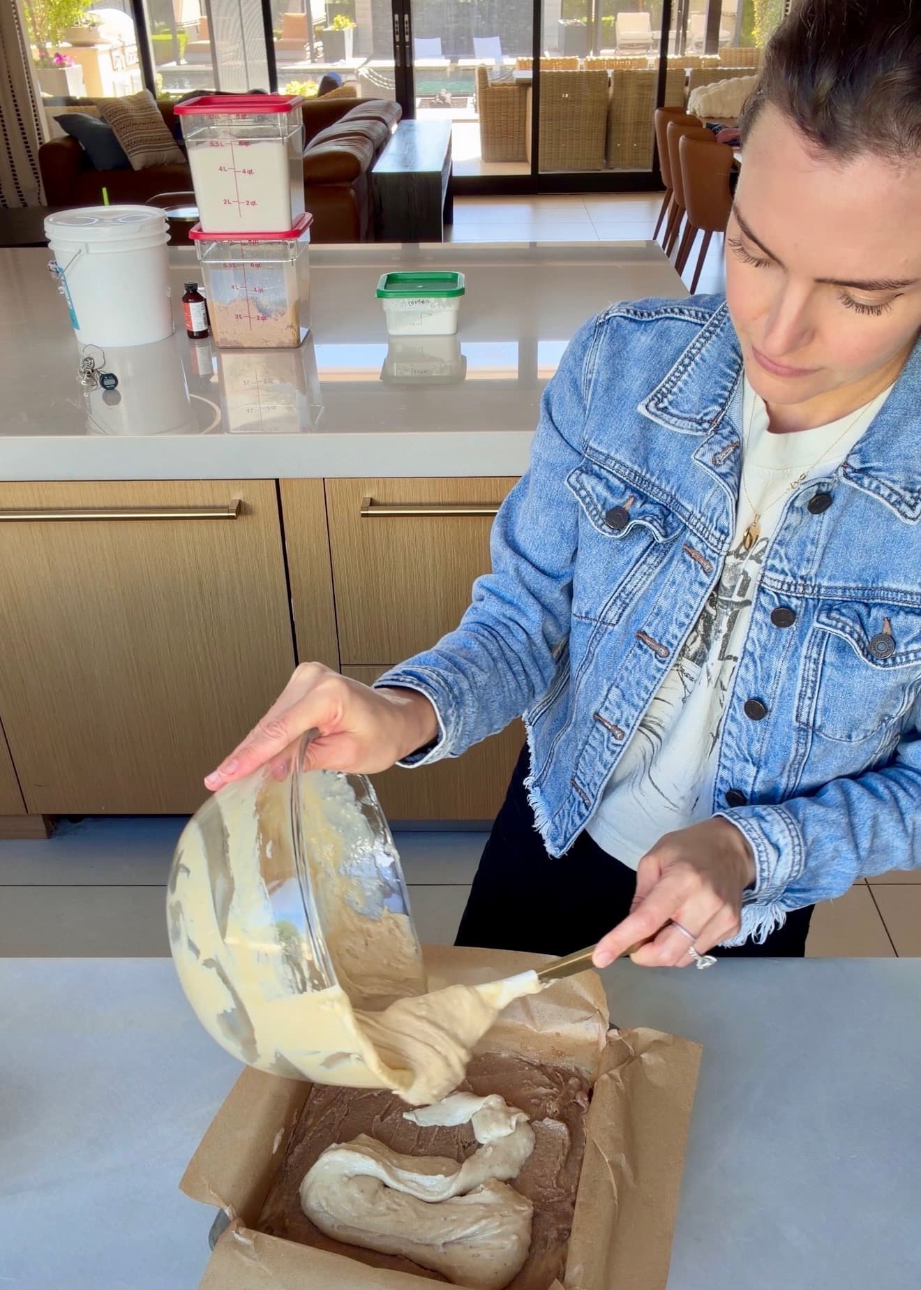 Remaining maple batter being added over the cinnamon filling