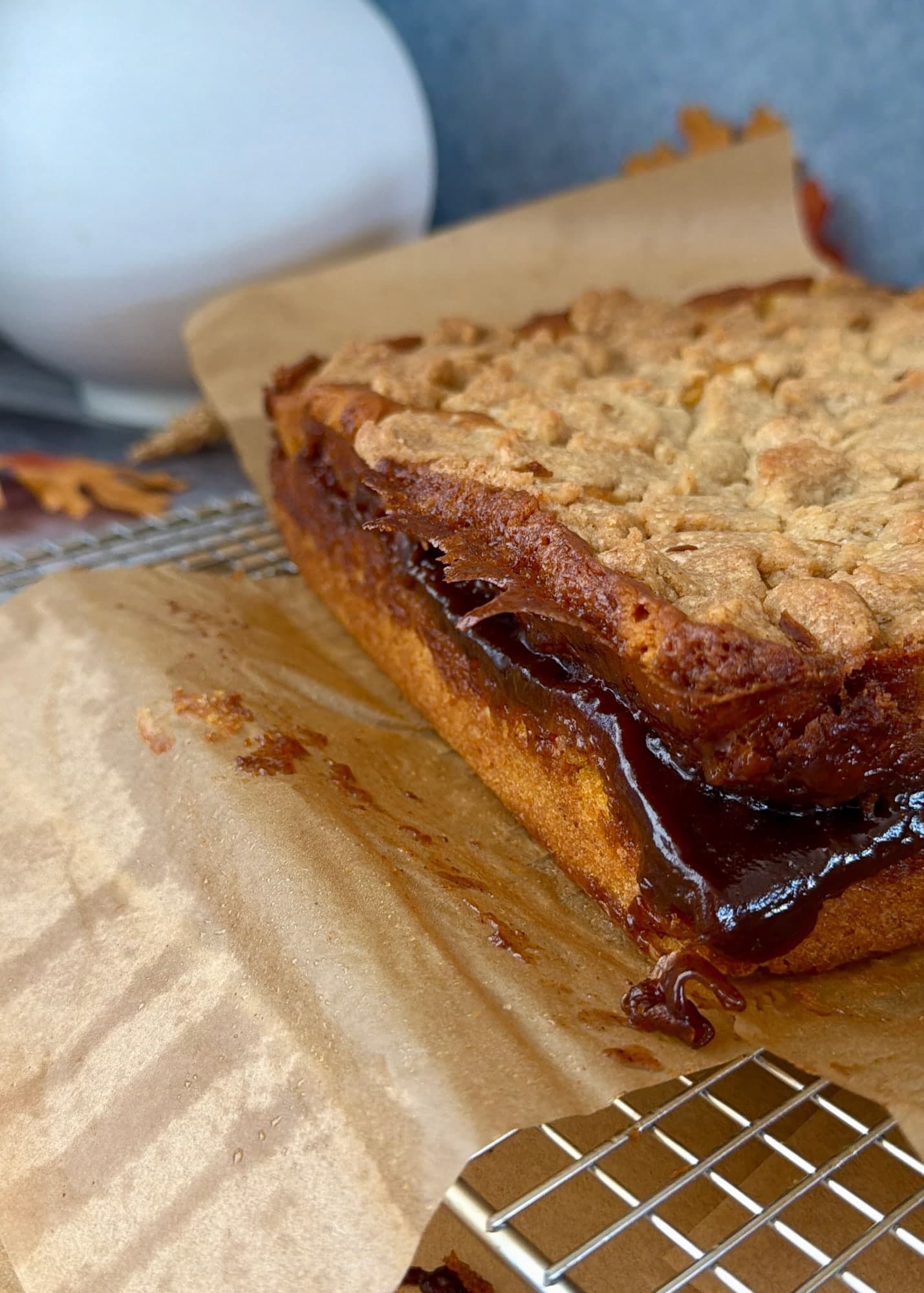 A glossy dark brown cinnamon ribbon along the unglazed pumpkin cake edge