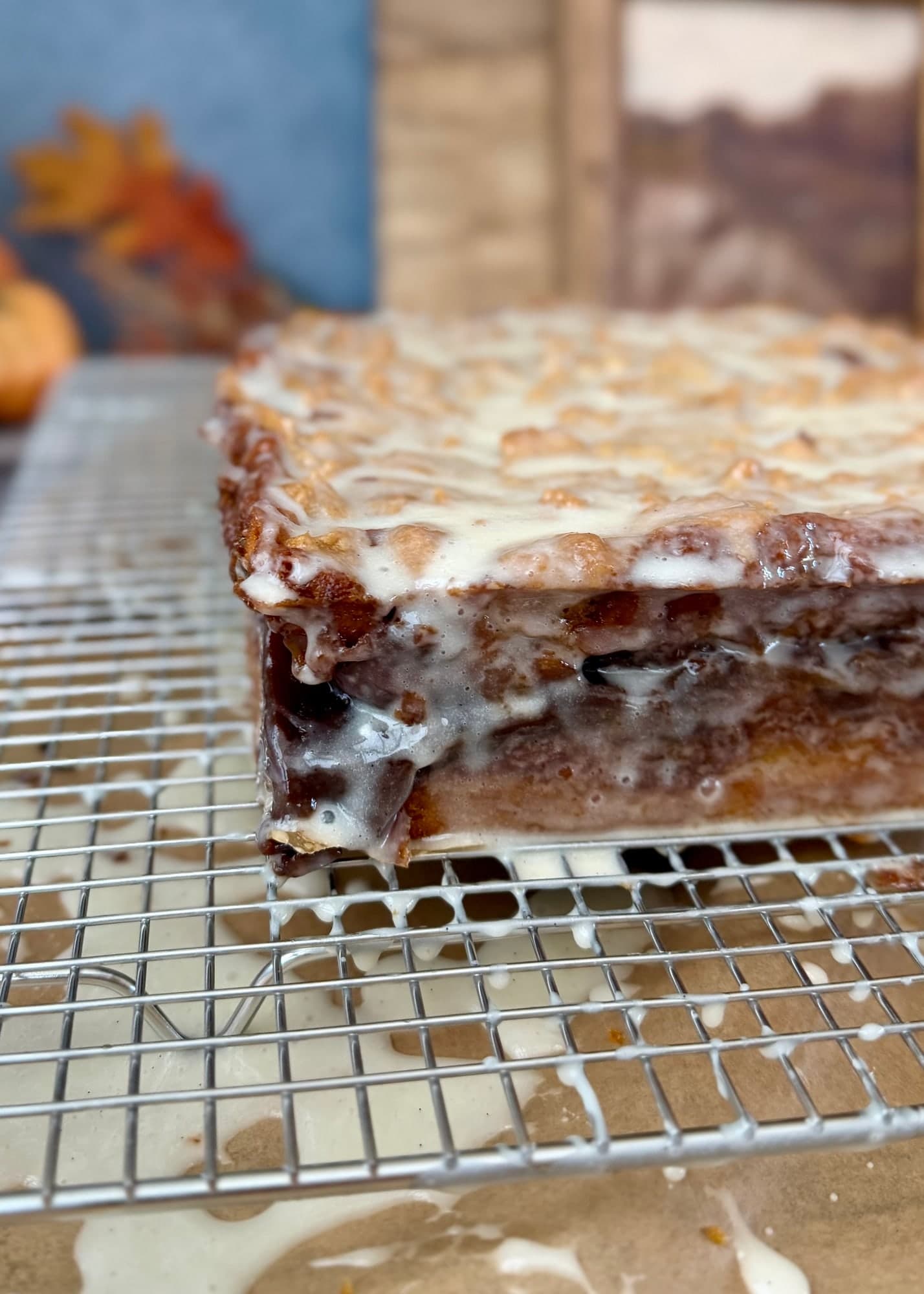 A lightly glazed caramelized corner above a wire rack and glaze drippings