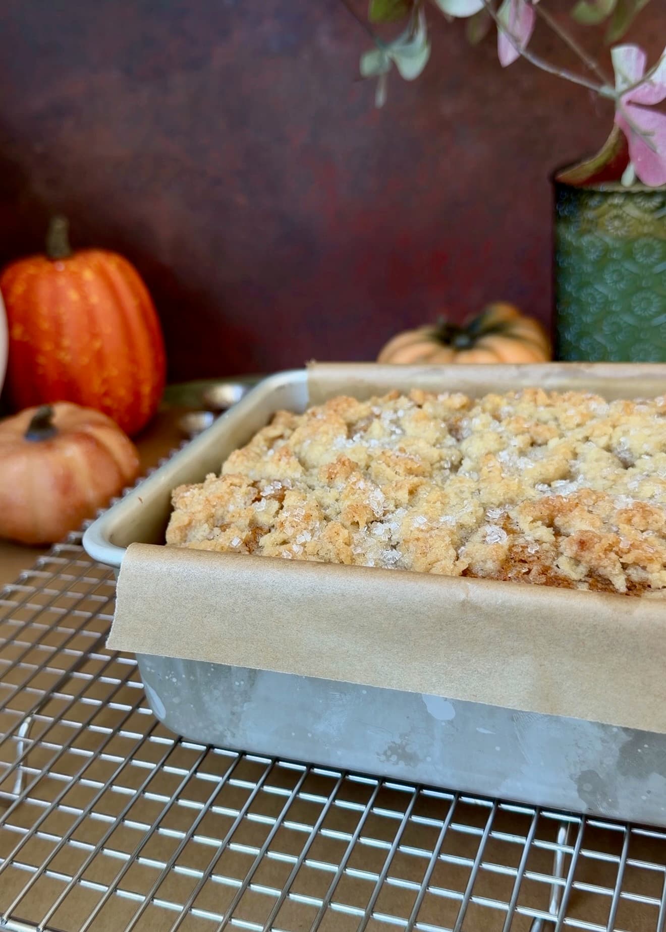 Freshly baked pumpkin spice donut loaf in an aluminum loaf pan