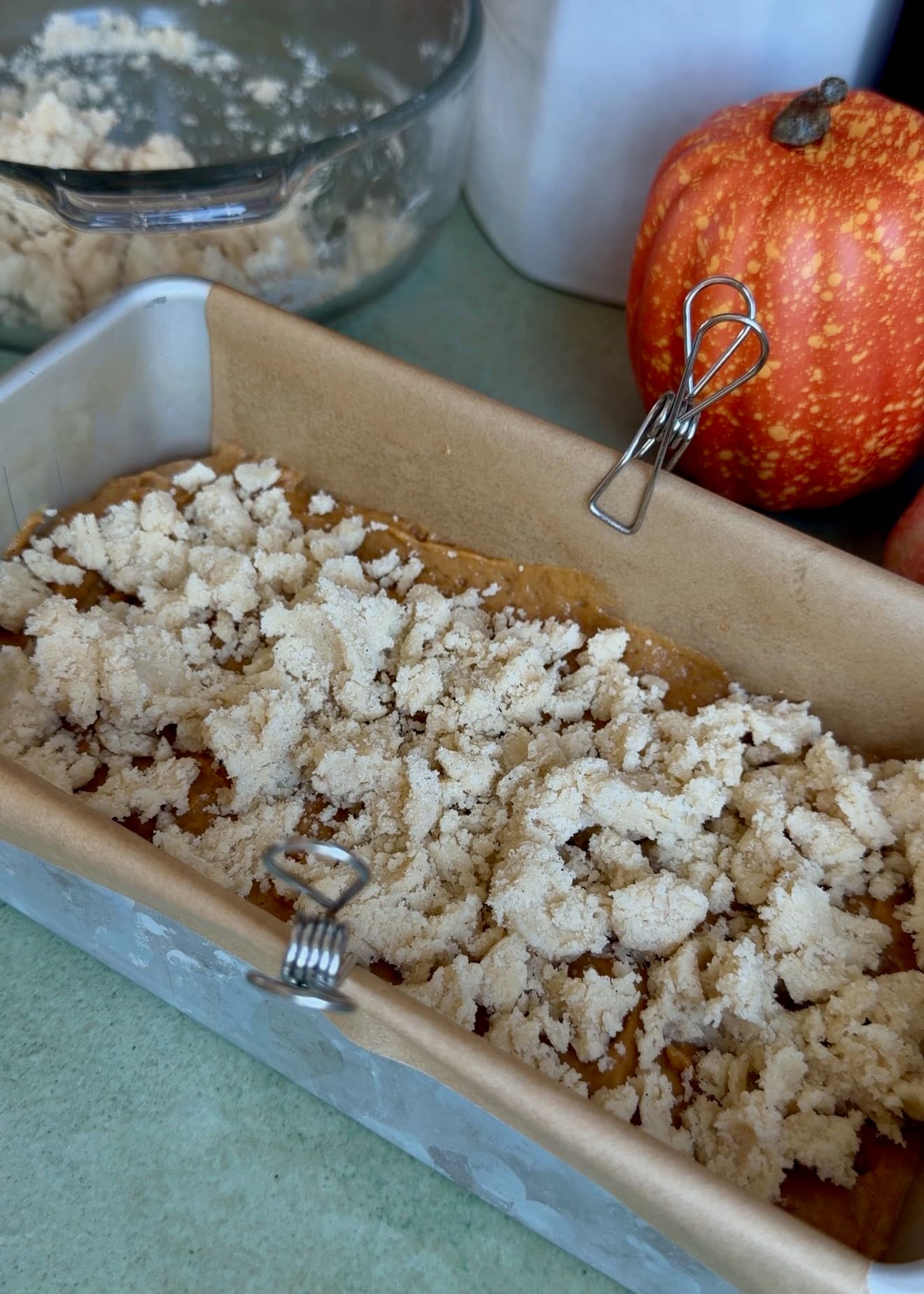 Buttery streusel covering the first layer of pumpkin spice batter