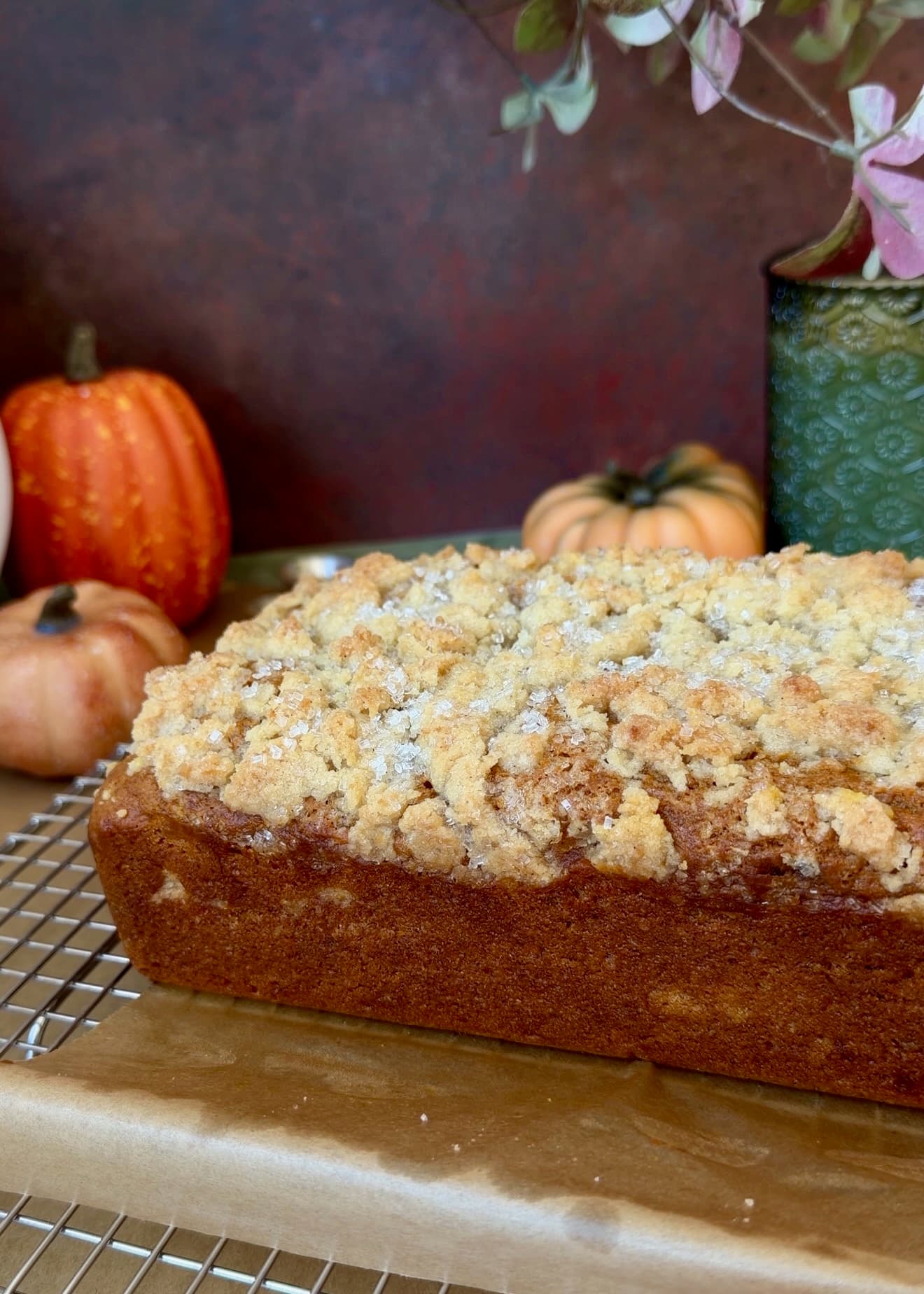 Unglazed pumpkin spice donut loaf cooling on a wire rack